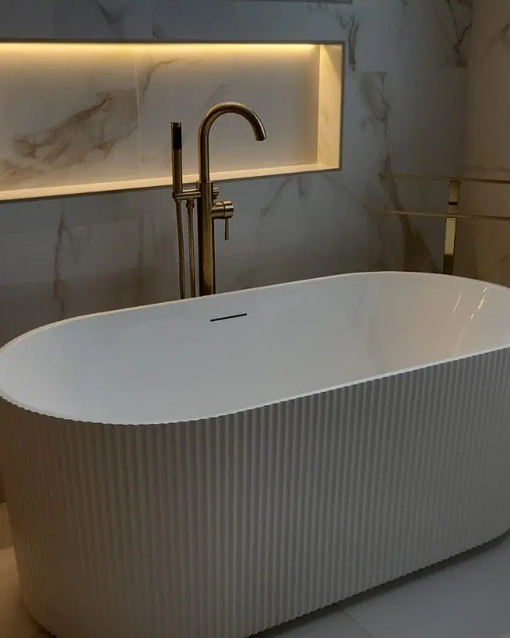 Freestanding Bathtub with Modern Design and Elegant Marble Wall.
