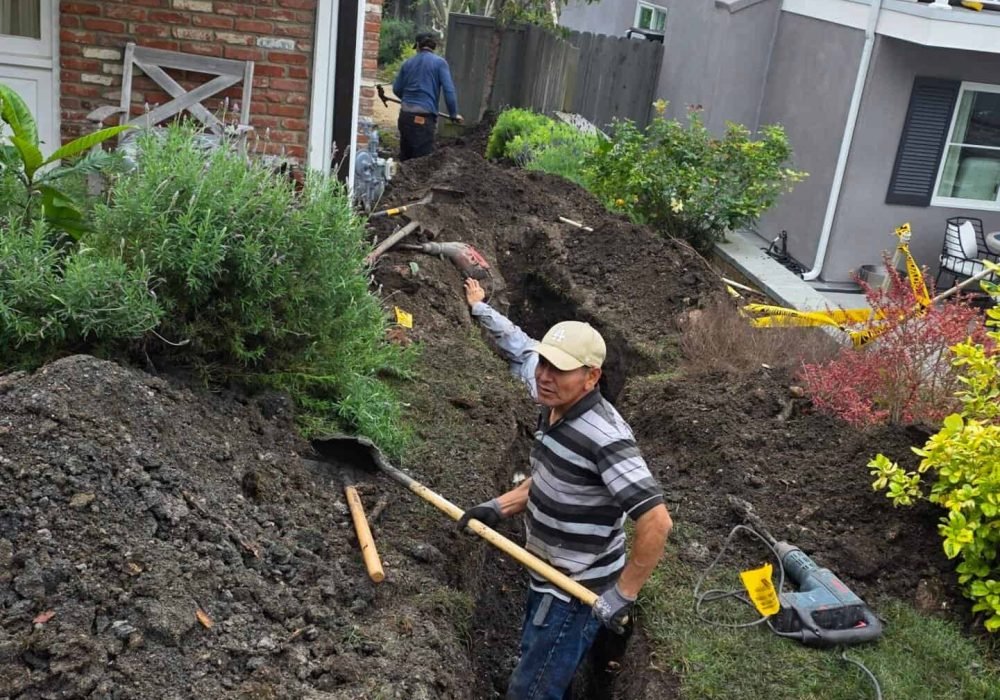 Excavation work for plumbing repairs in residential yard by Leak Be Gone Plumbing. Skilled technicia.